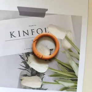 Orange metal spring ring 25mm snap hook round keychain accessory for bags and crafts.