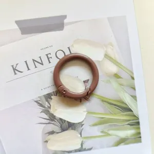 Brown metal spring ring detail, sturdy keychain clasp and bag accessory for daily hardware use.