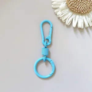 Detailed shot of the vibrant blue metal spring keychain clasp, highlighting the sturdy alloy mechanism.