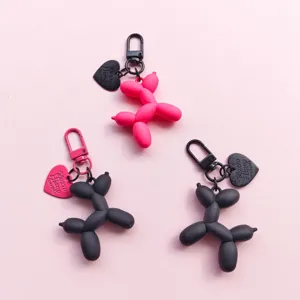 Cute balloon dog keychain with heart charm, stylish bag pendant accessory for women and couples.