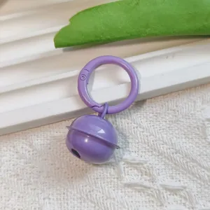 Purple metal candy color bell pendant with spring ring for DIY bag keychain accessory detail.