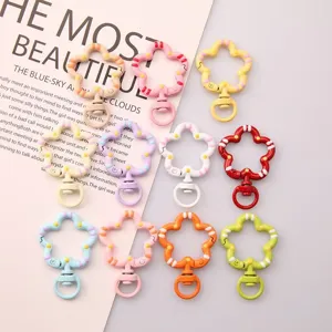 Colorful flower-shaped swivel lobster clasps for DIY jewelry and keychain accessories.