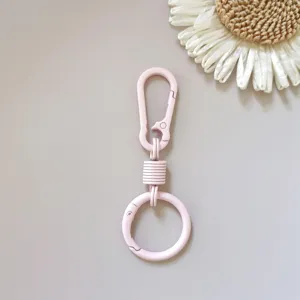 Pink zinc alloy spring keychain ring clasp hook, durable metal bag hardware accessory detail view.