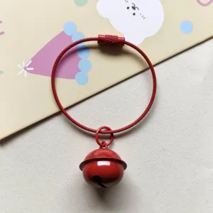 Red steel wire keyring detail view showing metal bell pendant and secure screw closure design.
