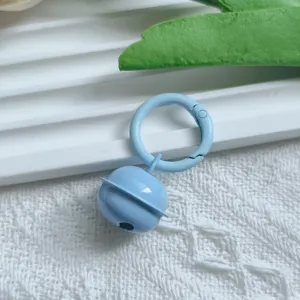 Detailed view of light blue metal candy color bell keychain pendant with spring ring.