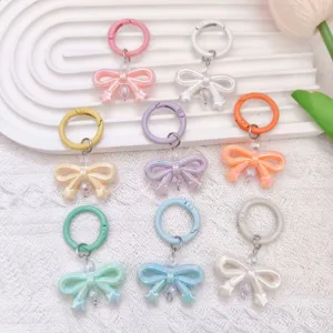 Colorful UV electroplated bow keychains with round spring clasps and bead chains for bags.