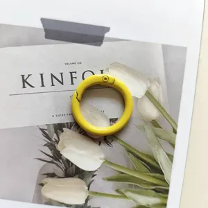 Yellow metal spring O-ring clasp hook for bags, keychains, and DIY craft accessories.