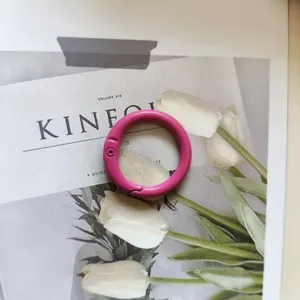 Pink metal spring ring detail, colorful O-ring keychain clasp for bags and crafts decor.