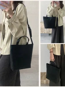 Detail view of the casual Korean minimalist solid black large capacity tote shoulder bag.