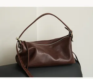 Detailed close-up view of the vintage brown cowhide leather hobo underarm shoulder bag.