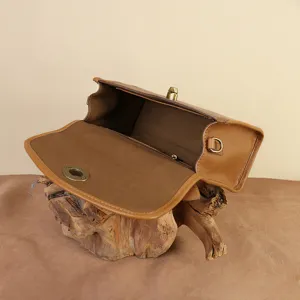 Classic vintage brown leather envelope messenger shoulder bag for women daily commute style.