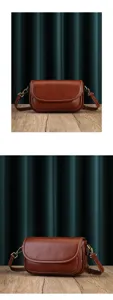 Brown leather crossbody bag detail view showing soft partition and delicate stitching craftsmanship.
