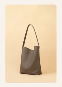 Detailed view of the brown leather shoulder bucket bag, featuring minimalist design.