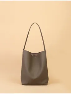 Minimalist leather bucket bag detail, soft cowhide single shoulder hobo purse for women daily.