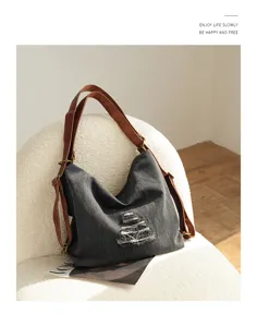 Vintage distressed denim backpack detail, multi-way casual shoulder bag with leather straps.