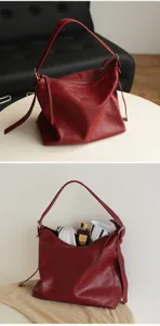 Detailed view of red leather shoulder underarm bag showcasing soft texture and inner space.