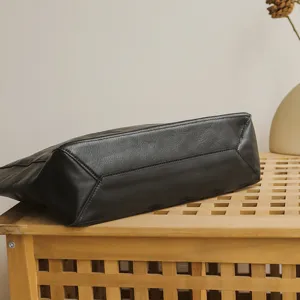 Genuine leather women's tote bag bottom view, retro black soft cowhide commuter handbag.
