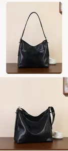 Detailed view of the black leather shoulder bag showing soft texture and sleek minimalist design.