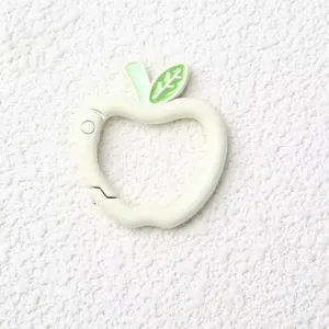 Close-up detail view of the cute apple-shaped spring ring clasp with green leaf accent.