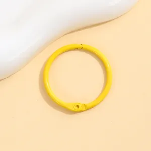 Yellow metal loose-leaf book ring detail view, vibrant colored keychain accessory for DIY crafts.