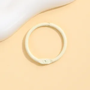 Detail view of a beige painted metal loose leaf binder ring, perfect for DIY crafts and accessories.