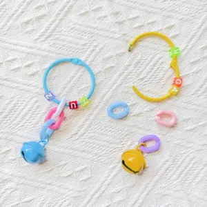 Colorful DIY plastic chain rings, letter beads and small bells for phone charms and keychains.