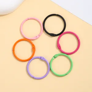 Closeup of colorful metal binder rings, DIY craft accessories and key ring loops detail view.
