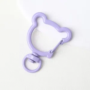 Close-up detail of light purple bear-shaped alloy keychain swivel hook for DIY crafts.