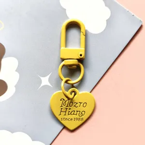 Cute candy color metal baking paint keychain with heart pendant, stylish bag accessory.