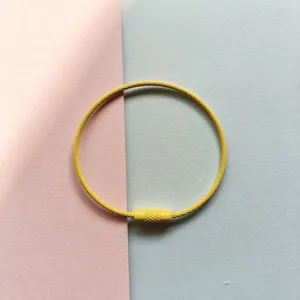 Nahaufnahme Detail der gelben beschichteten Stahldraht-Schlaufe mit einem Schraubverschluss.
