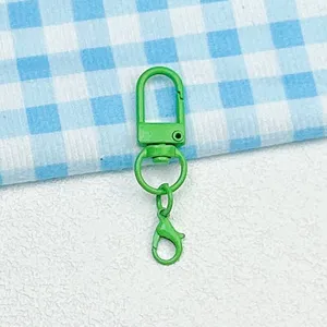Green metal lobster clasp swivel snap hook keychain DIY bag doll accessory detail shot
