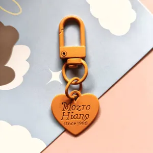 Creative candy color metal DIY painted keychain with cute pink heart pendant and clasp item.