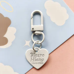 White metal keychain with heart pendant, cute design for DIY bags and keys accessories.