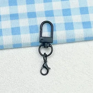 Close-up detail of black metal swivel lobster clasp keychain accessory for DIY bags.