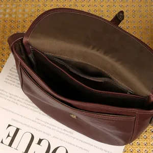 Genuine leather vintage brown saddle bag, open view showing large capacity interior.