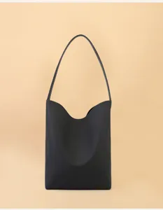 Minimalist black leather shoulder bag with curved top design, spacious daily hobo style.