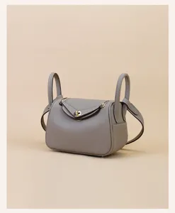 Mini leather crossbody shoulder bag grey doctor bag with elegant gold hardware design.
