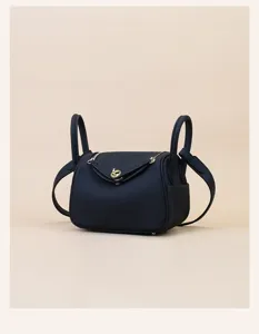 Detailed view of mini leather handbag, classic doctor bag shape with gold hardware.
