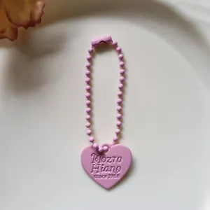 Detail view of the cute pink heart bead chain keychain pendant, lovely bag charm accessory.