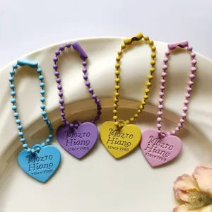 Heart-shaped double-sided beaded chain keychain pendant, colorful minimalist style accessory.