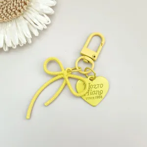 Gelber Legierung Schleife Schlüsselanhänger mit Herz Anhänger süße Tasche Charm Zubehör