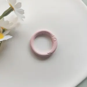 Pink metal spring ring clasp close-up, durable handbag hardware accessory replacement part