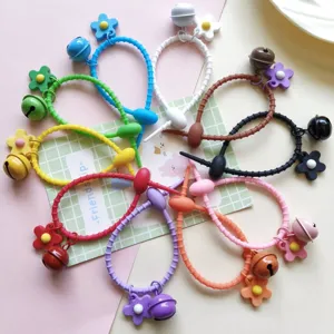 Colorful silicone cable ties with bells and flower charms for DIY bag pendants.