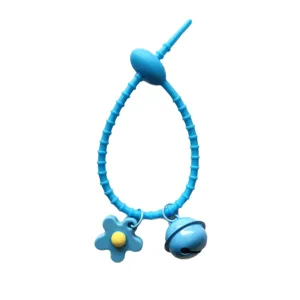 Blue silicone cable tie keychain with cute flower and bell pendant for DIY bag accessories.