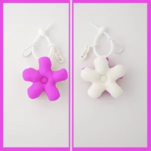 Cute plush flower bag charm with white knot strap, double-sided color, detailed keyring pendant.