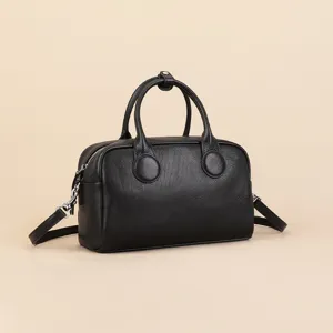 Classic black leather Boston bag with top handles and adjustable crossbody strap for women.