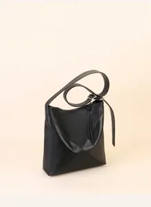 Detailed shot of a black soft leather hobo crossbody bag featuring geometric panel design.