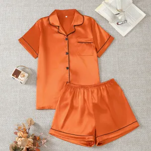 Women orange silk satin short sleeve pajama set with shorts, lapel collar and pockets.