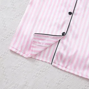 Pink and white striped satin pajama shirt detail view showing black piping and buttons.
