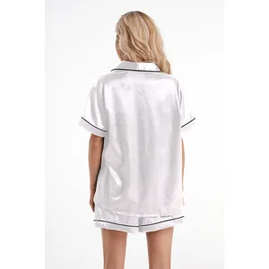 Back view detail of white silk pajama set with black piping, soft and comfortable sleepwear.